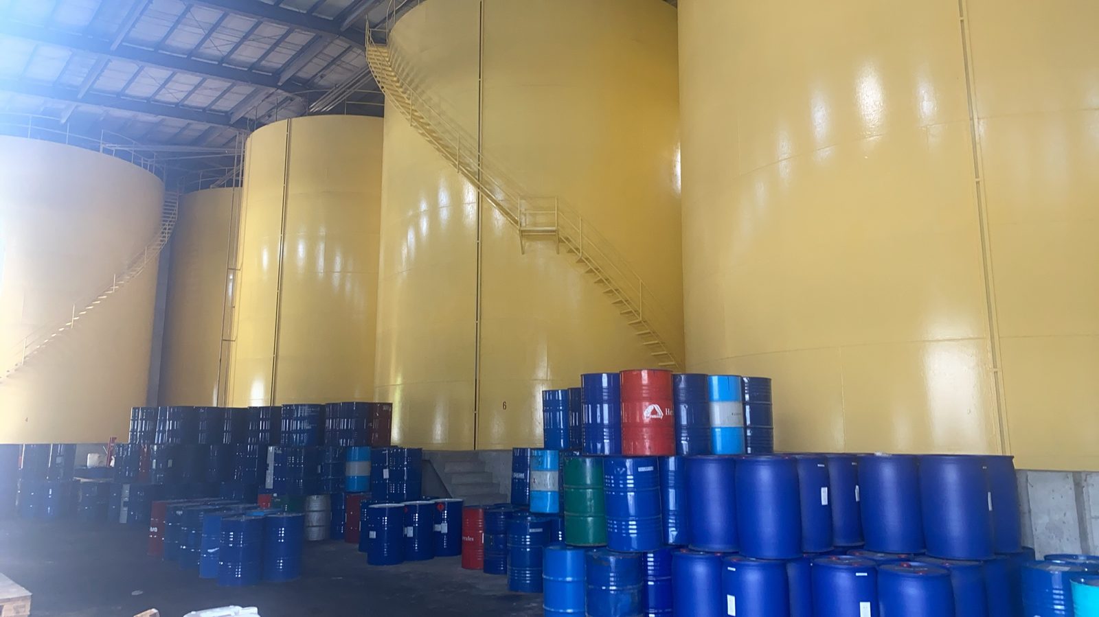 Yellow bulk tanks and packaged drums at CFI Changhua